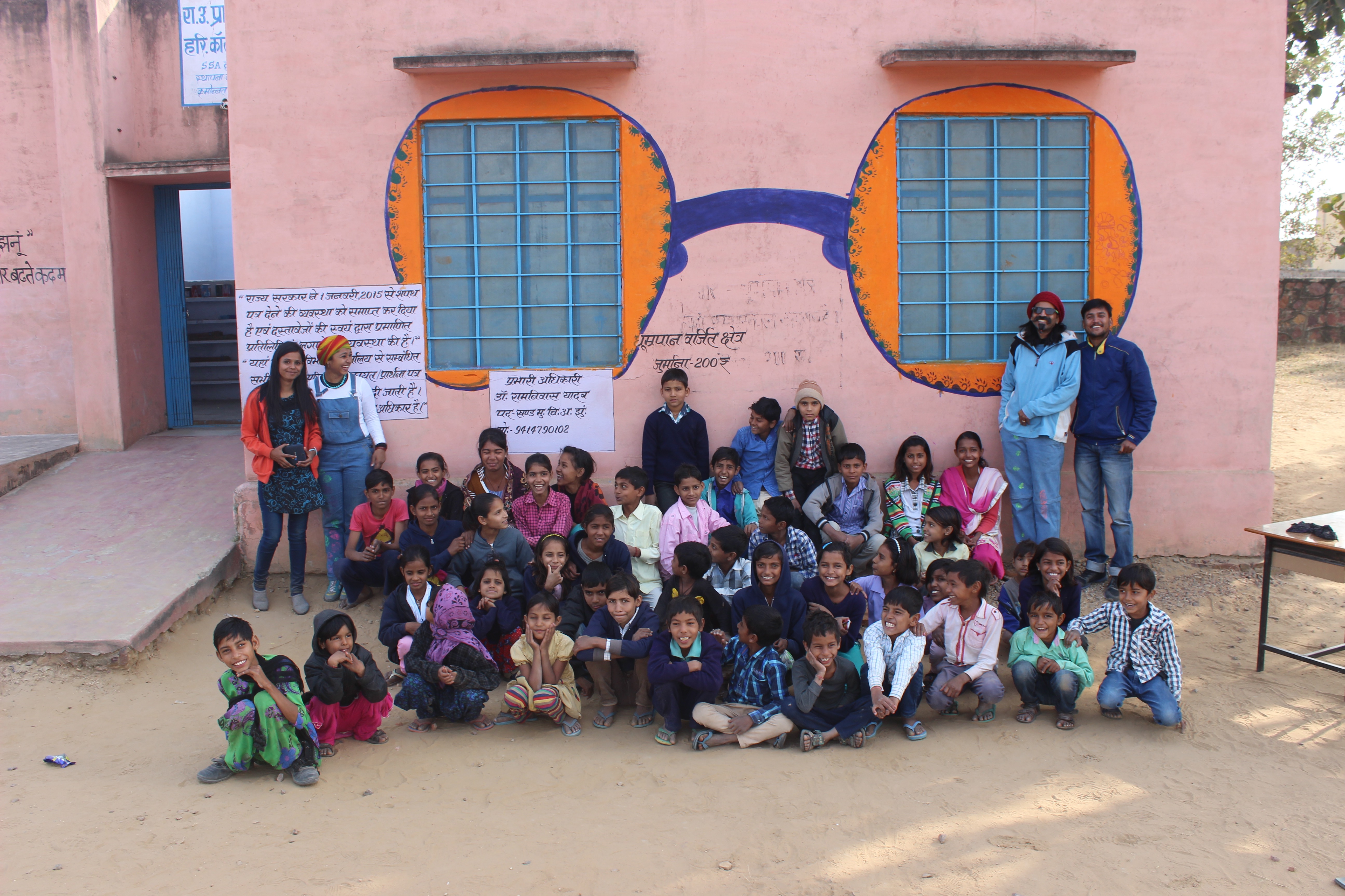 A mural on the wall painted with kids in a village school